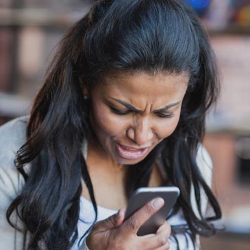 woman angrily reading text messages